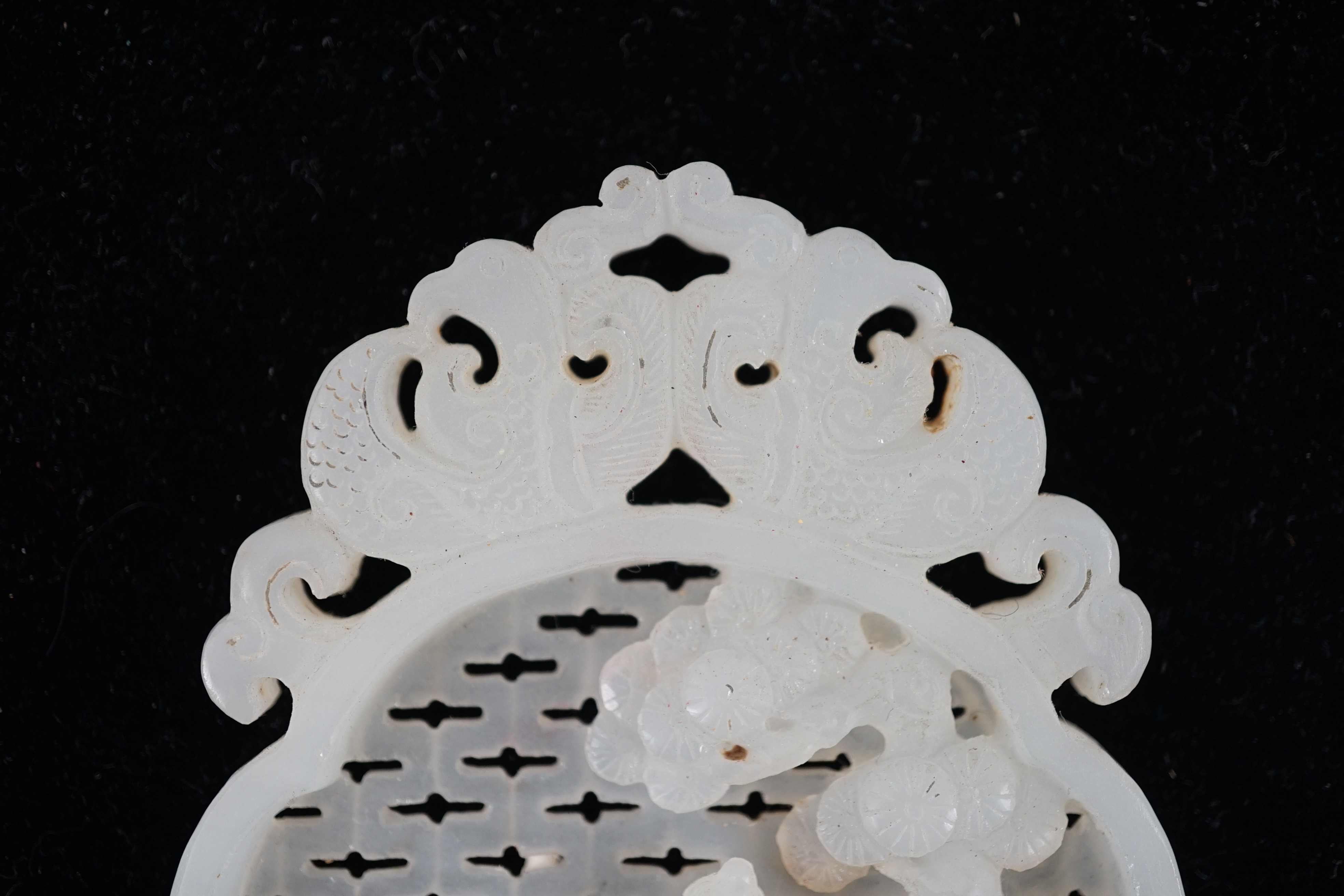 A Chinese white jade reticulated plaque, 19th century, 10.2cm high